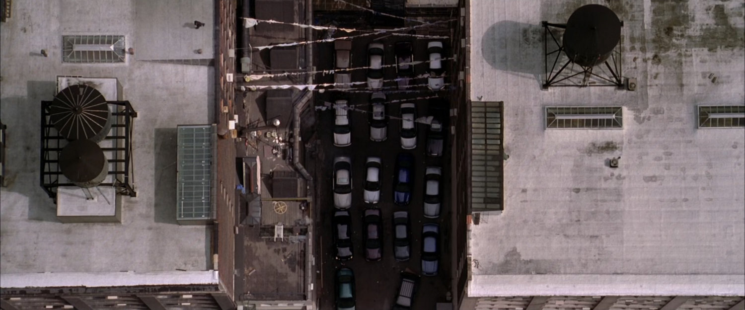 Aerial view of rooftops and alley.