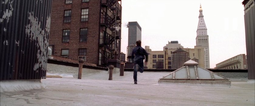 Peter Parker runs on rooftop.