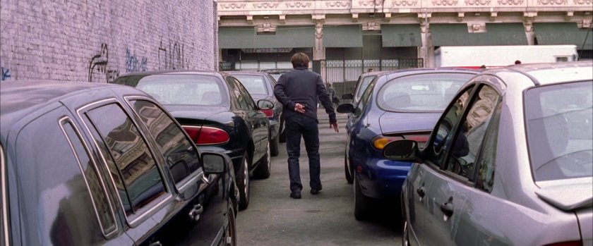 Peter Parker walking through parking lot.