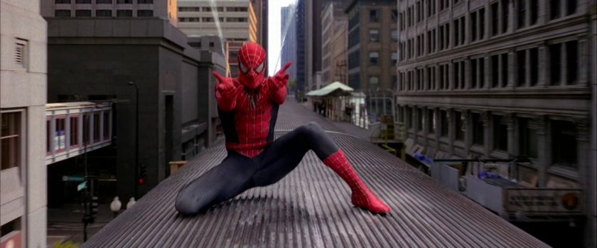 Spider-Man shooting webs on speeding train.