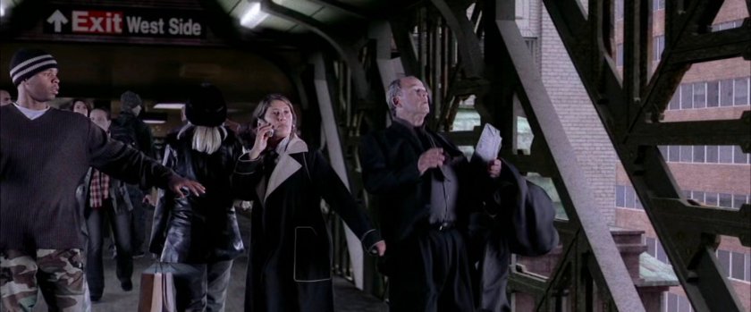 Onlookers on train overpass.