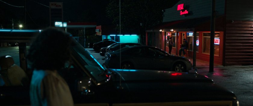 Jennifer Walters watches the doorman in front of the Ideal Sports Bar.