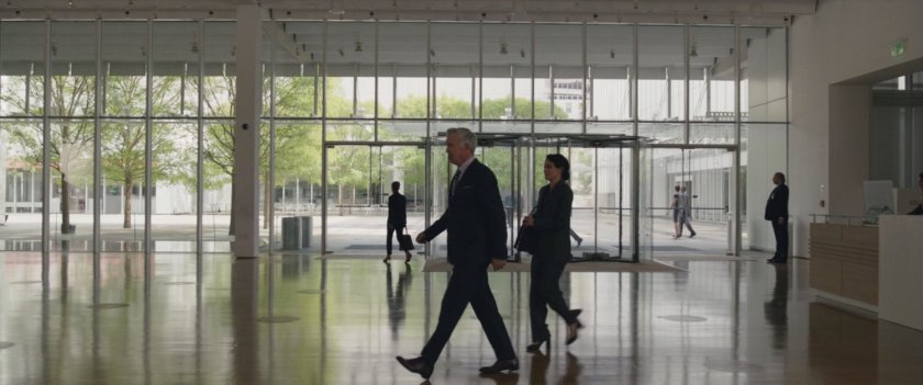 Holden Holliway and Jen walters walk across the front lobby of Jen Walters walks across the courtyard of GLK&H.