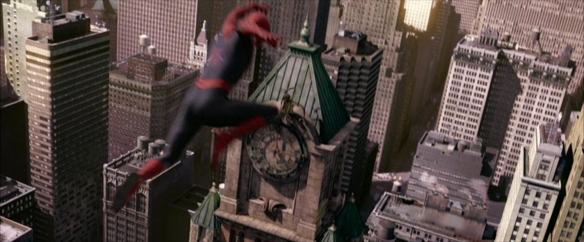 Spider-Man leaps through air towards clock tower.