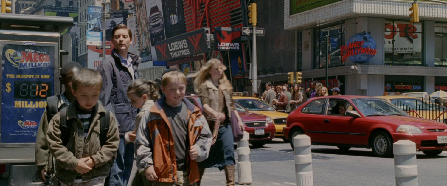 Peter Parker watches children walk away in Times Square.