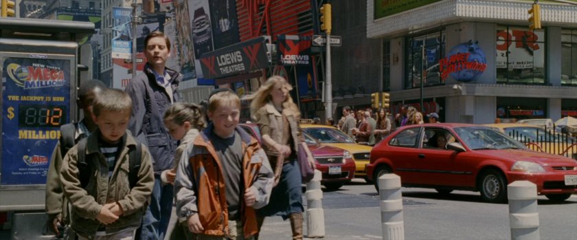 Peter Parker watches children walk away in Times Square.