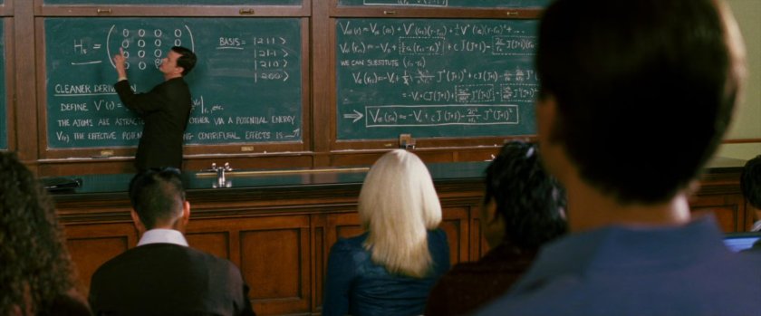 Doctor Connors at a chalk board in college classroom.