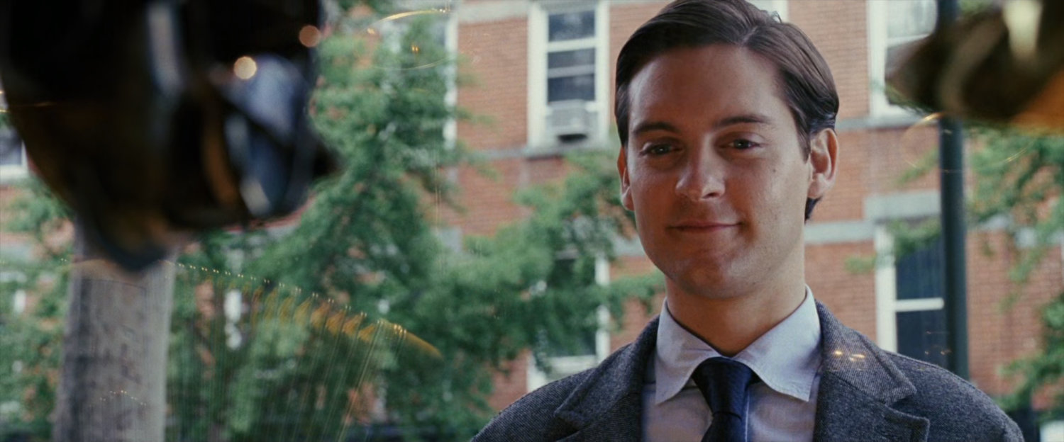 Peter Parker looking into pawn shop window.