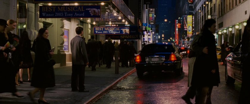 Peter Parker watching car drive away outside theater.