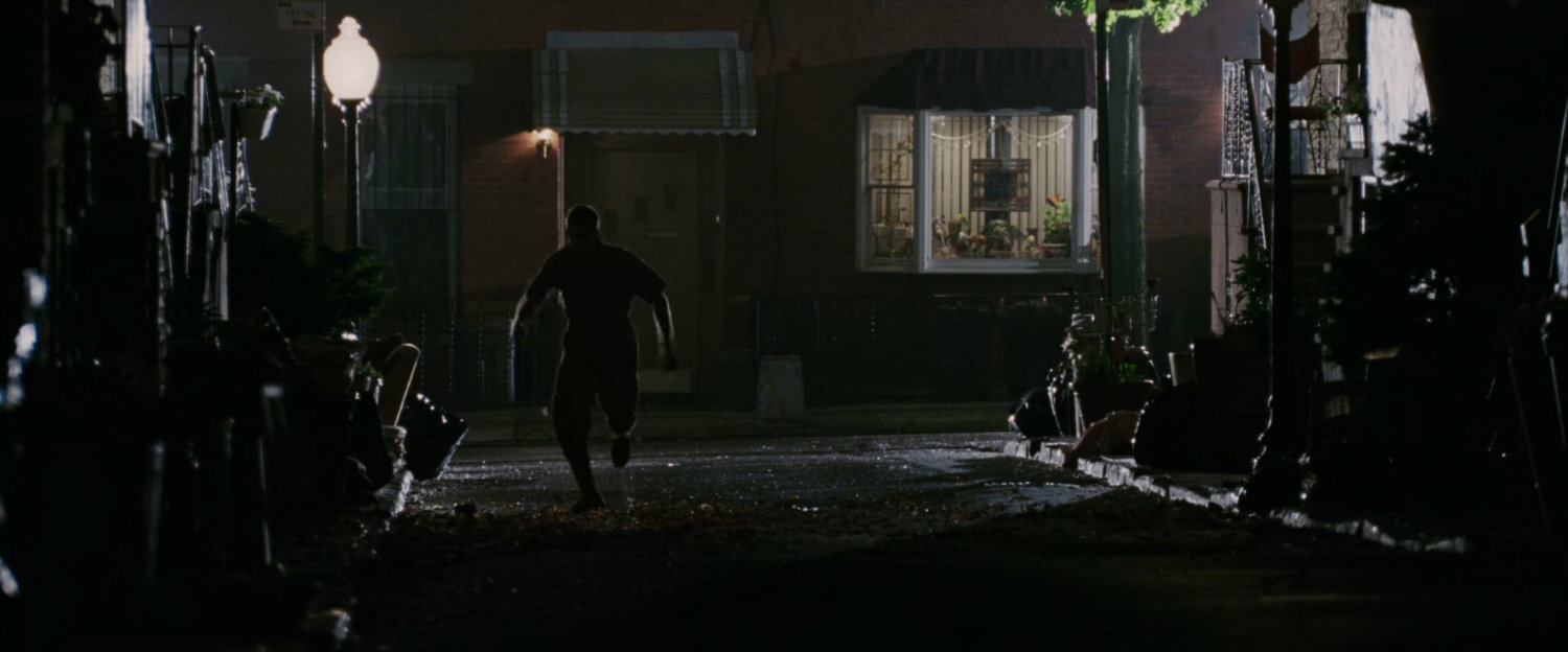 Flint Marko running down dark street.