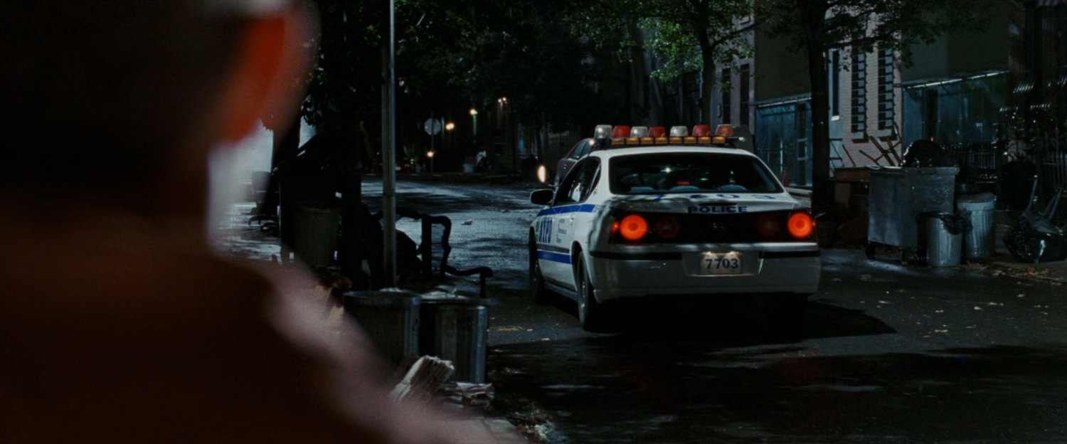 Police car on dark street.