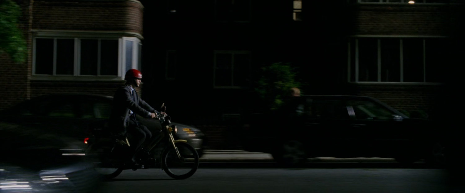 Peter Parker on Moped at night.