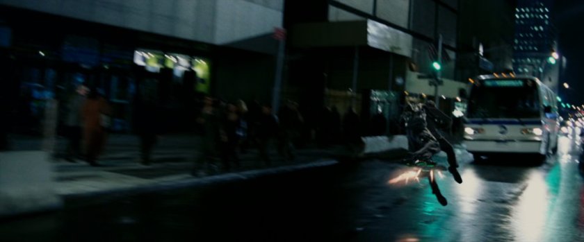 Goblin attacking Peter parker on street in front of city bus.