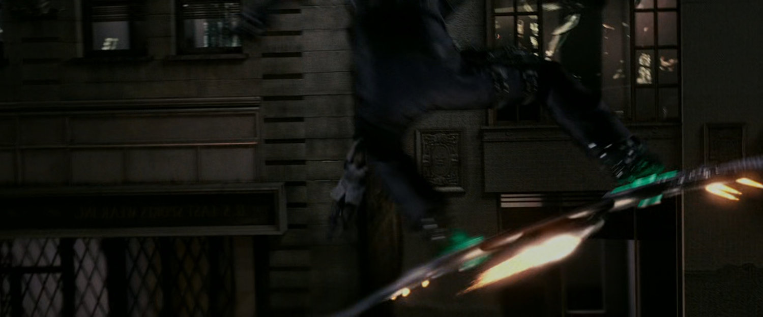 New Goblin flying past building in alley.