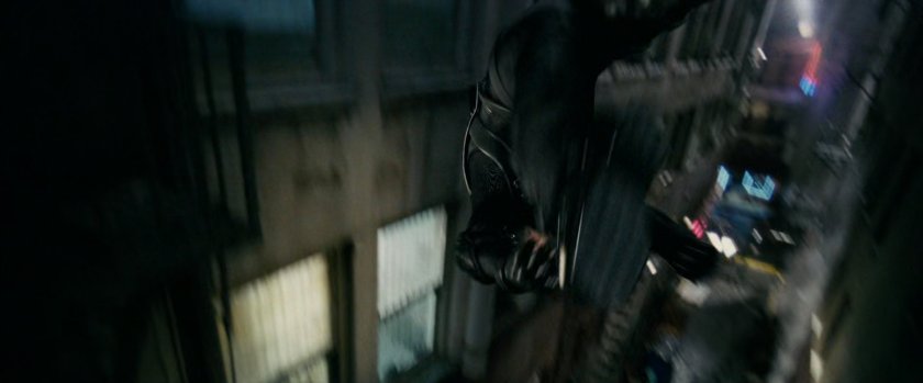 New Goblin flying past building in alley.