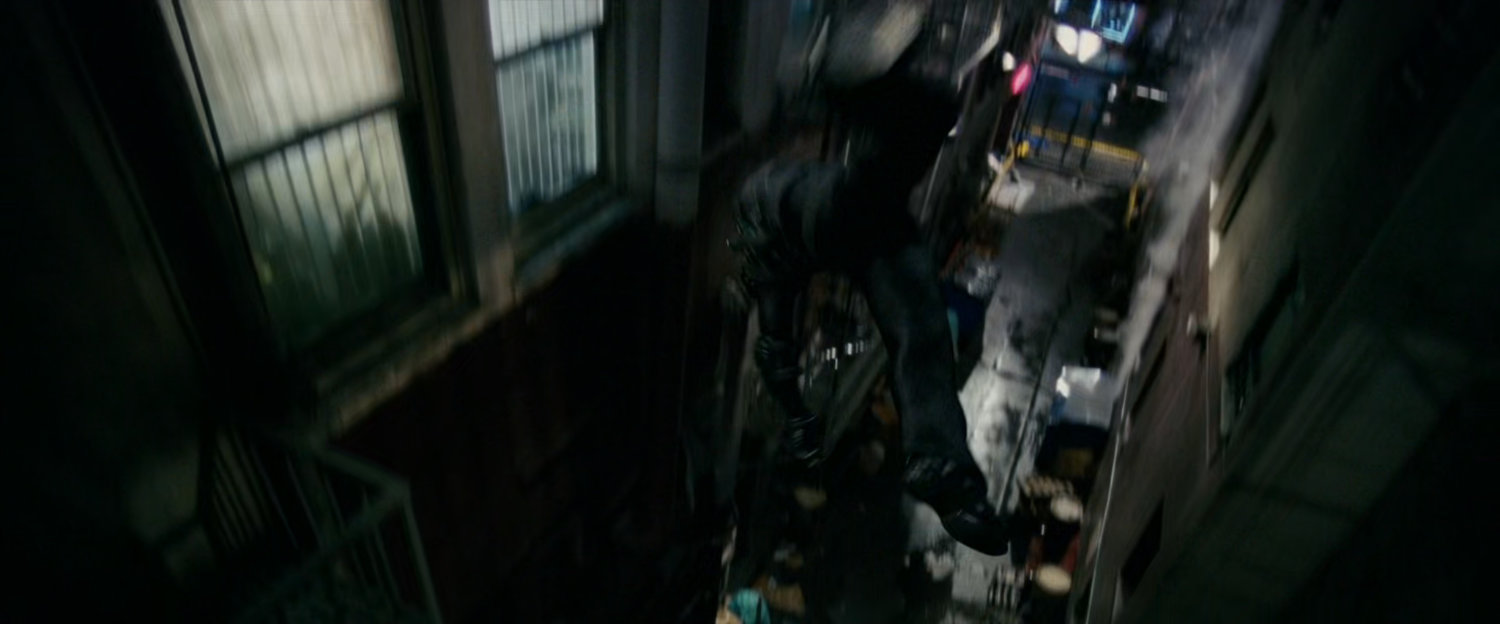 New Goblin flying past building in alley.