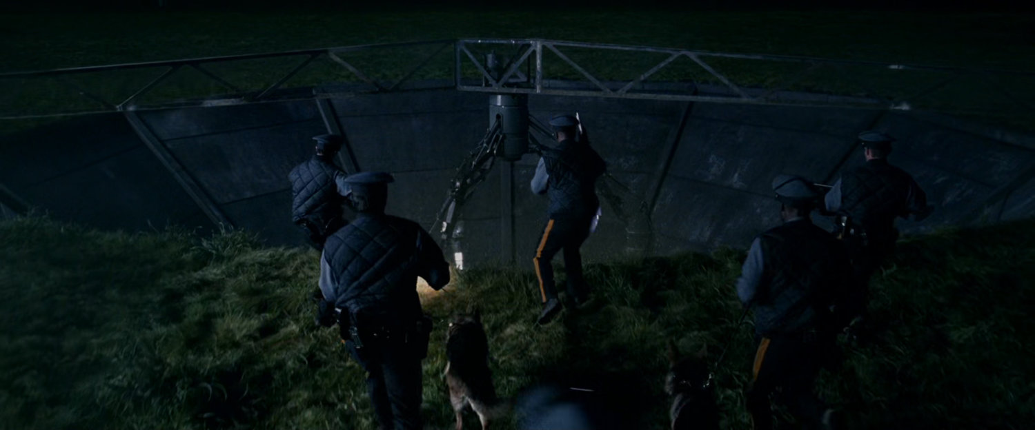 Police at night looking into the Particle Physics Test Facility.