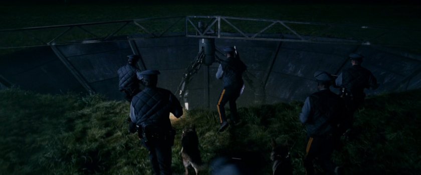 Police at night looking into the Particle Physics Test Facility.
