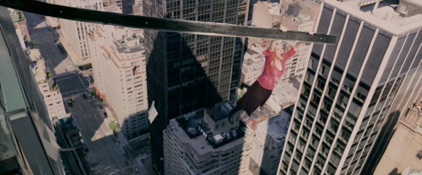 Gwen Stacy hangs on to building girder, dangling over street.