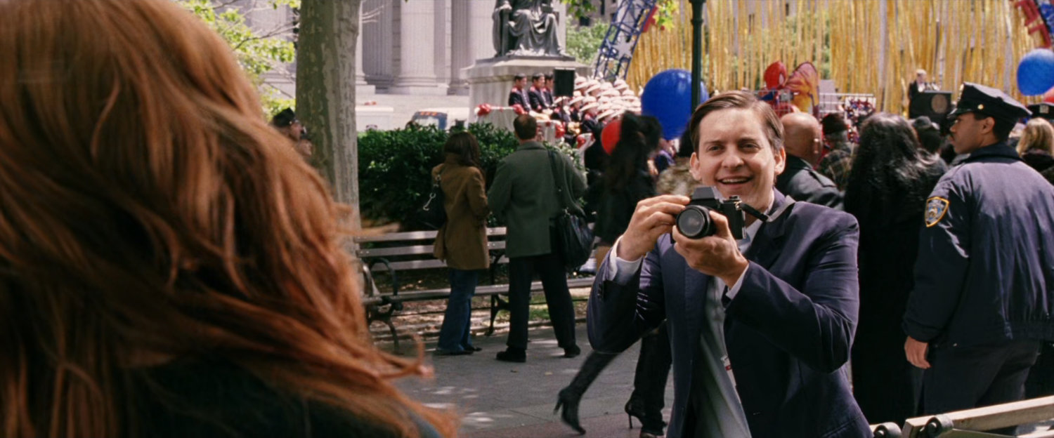 Peter Parker taking photo at Spider-Man Day event.