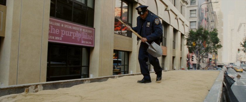 Police officer investigates truck filled with sand.