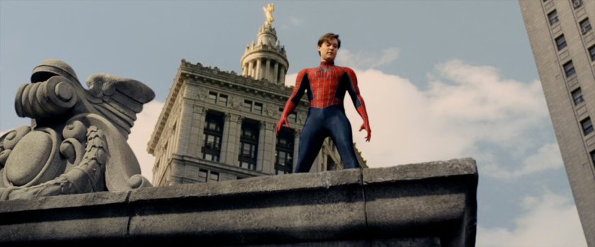 Spider-man on the ledge of a building.