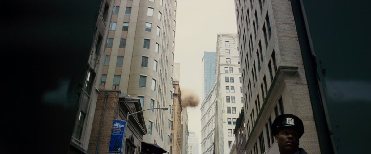 A sandstorm climbs into a narrow street.