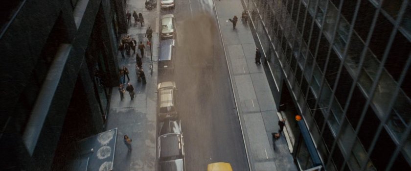 A sandstorm blowing down a narrow street.