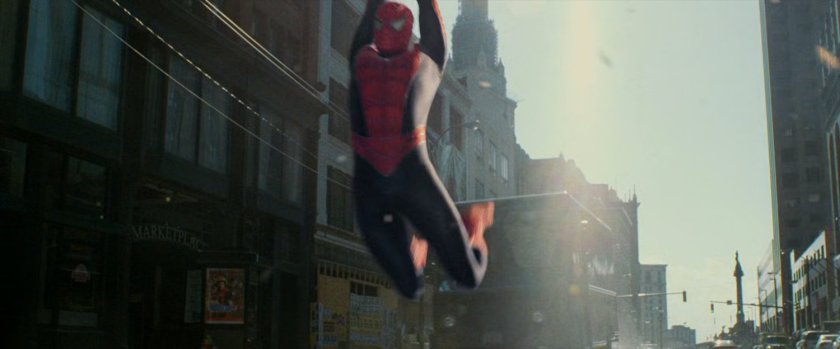 Spider-Man swings into street.