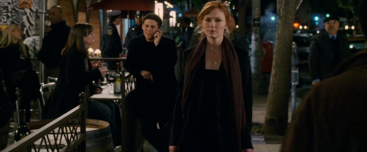 Mary Jane walking down the sidewalk at night.