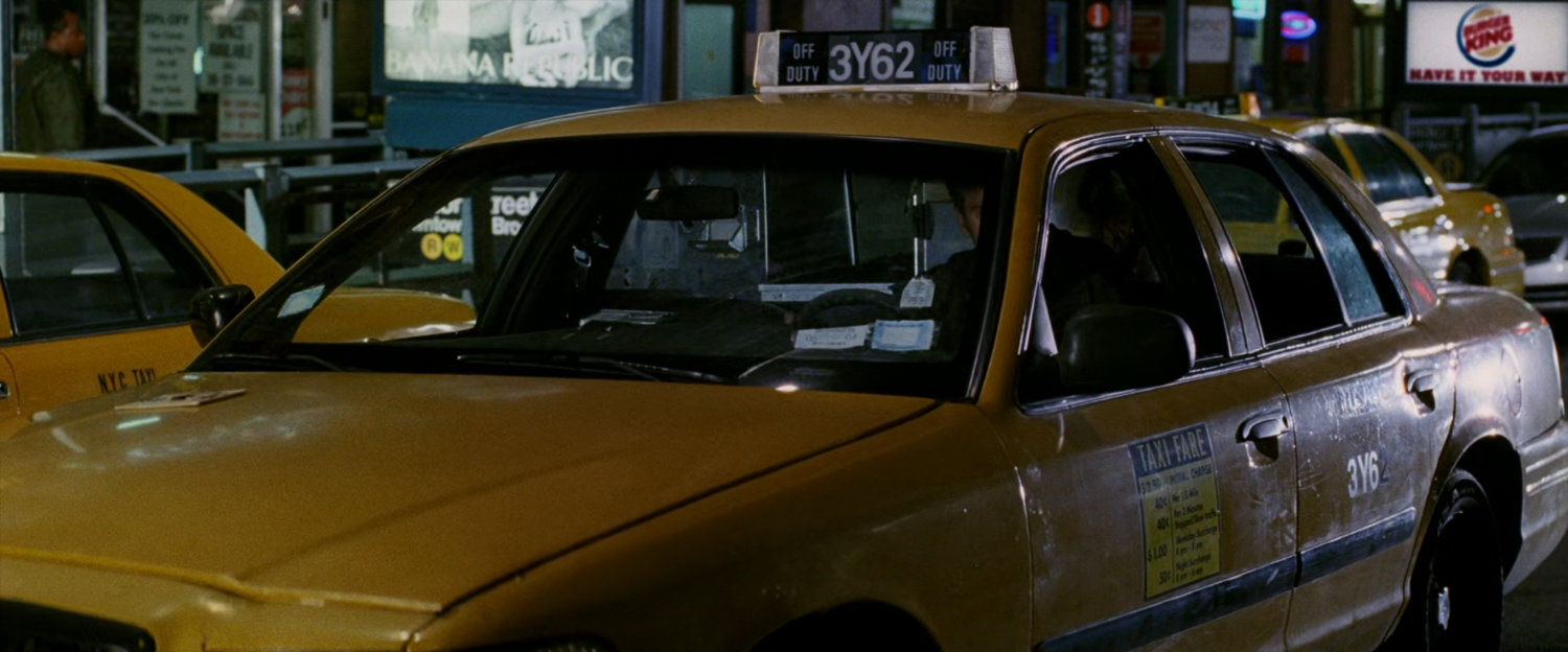 Yellow cab outside First Eastern Bank.