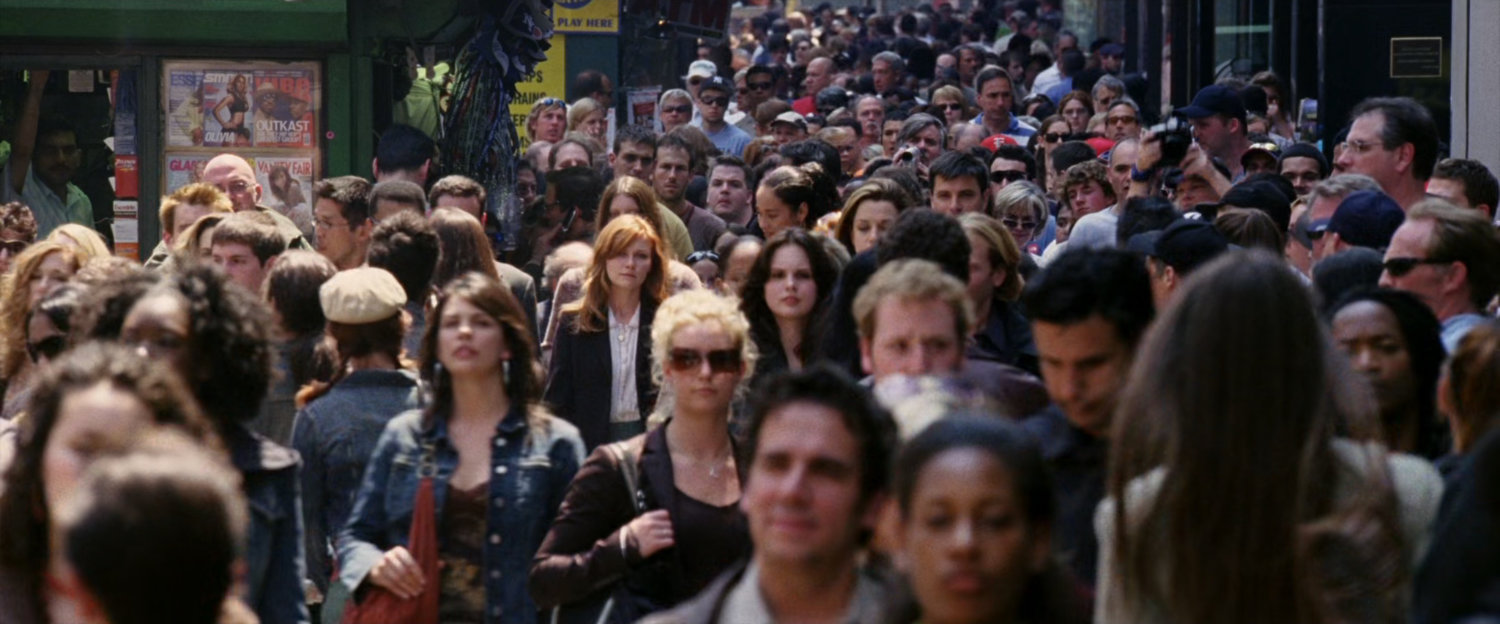 Mary Jane in crowd of pedestrians on the sidewalk.