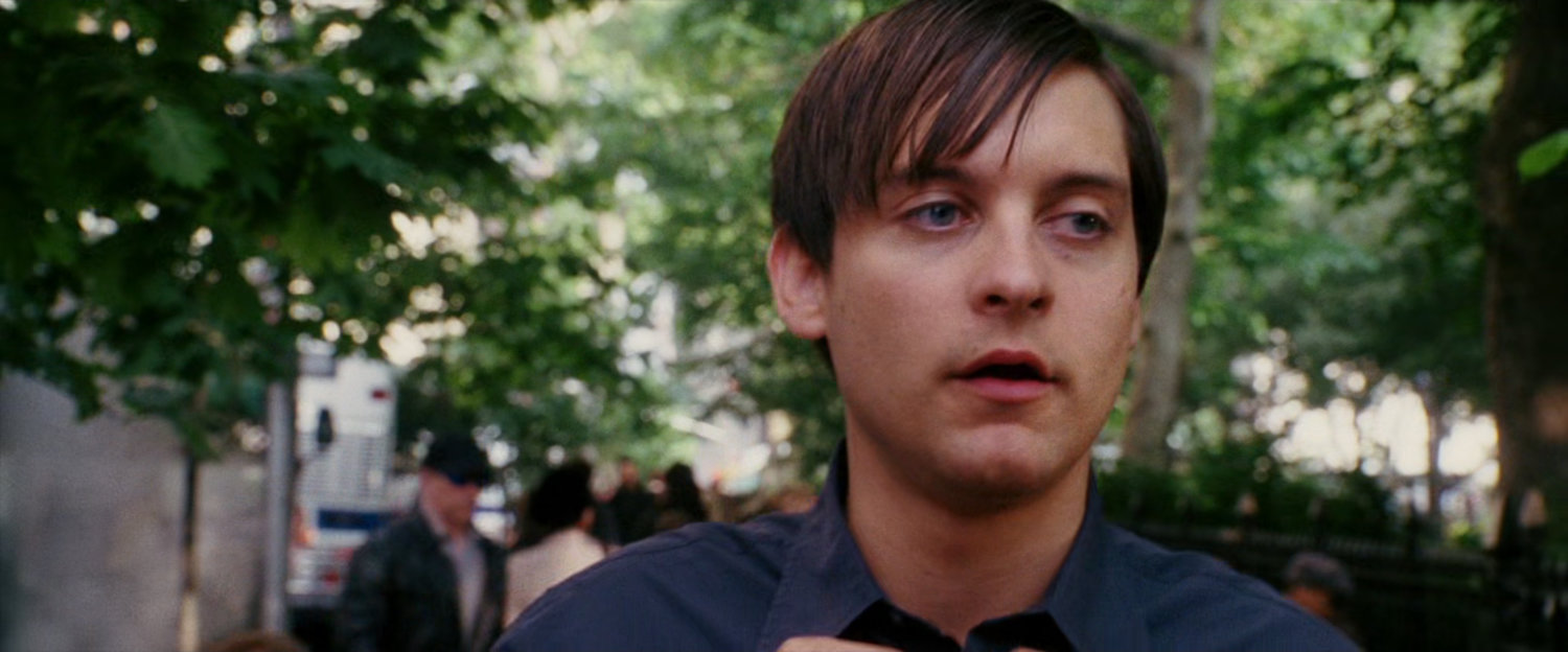 Peter Parker walking by park.