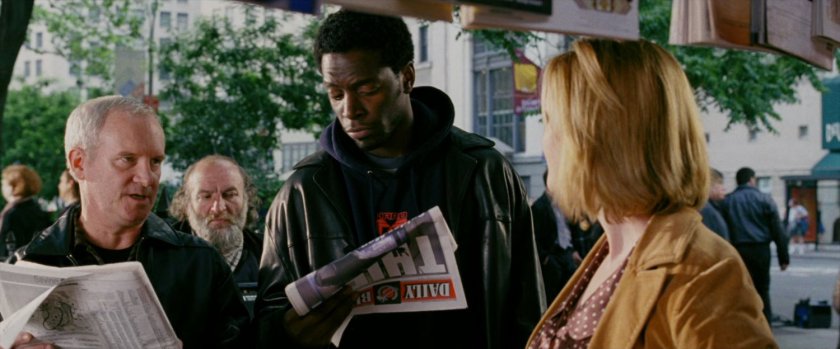 People looking at newspapers at corner newsstand.