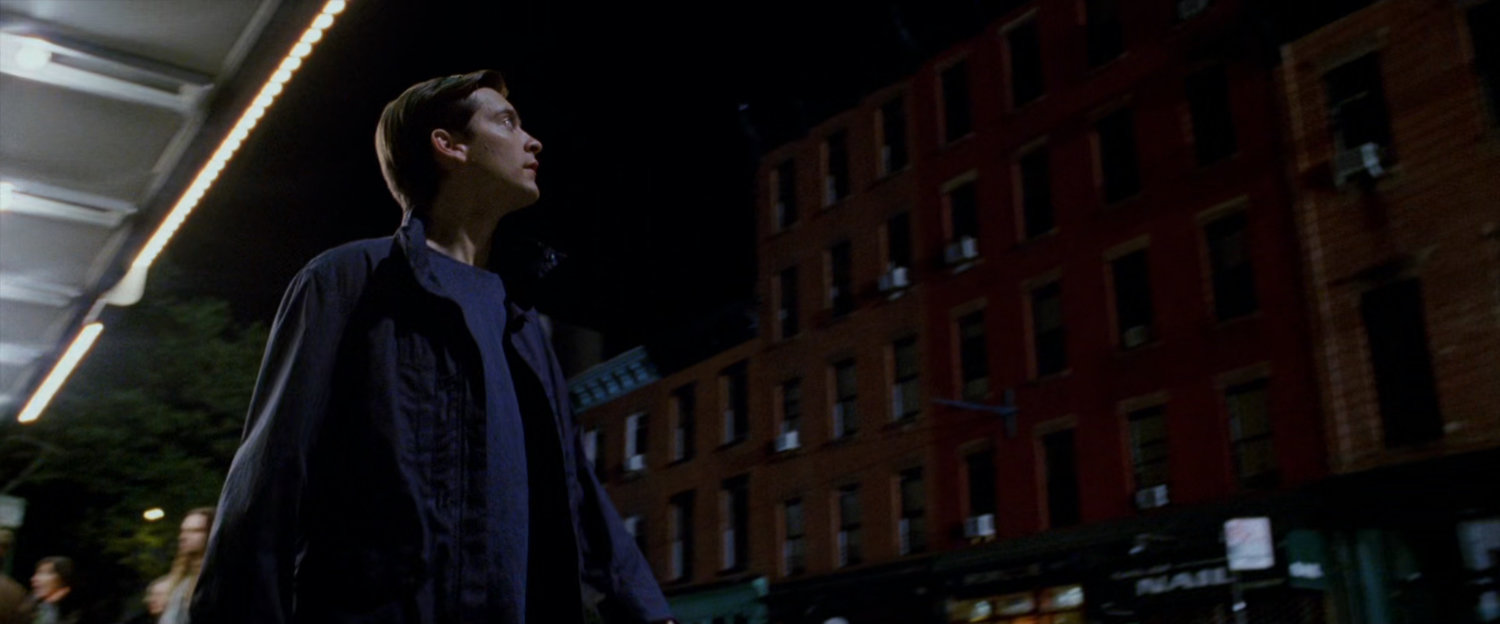 Peter Parker looking up at building.