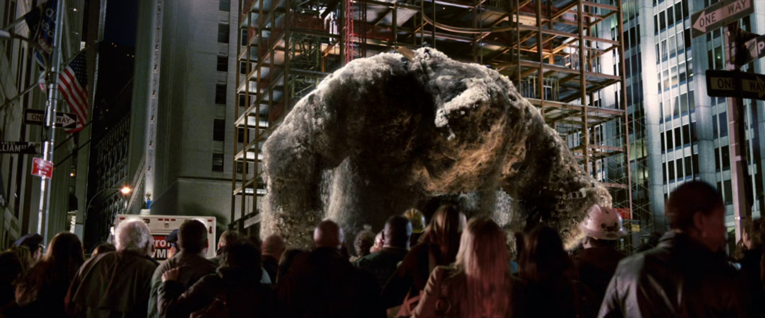 A large Sandman reaches for onlookers at construction site.