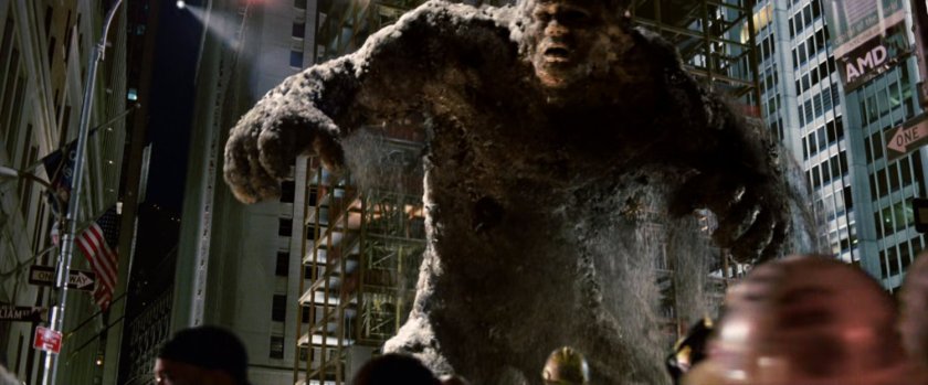 A large Sandman reaches for onlookers at construction site.