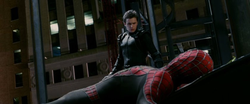 Harry Osborn looks over a prone Spider-Man.