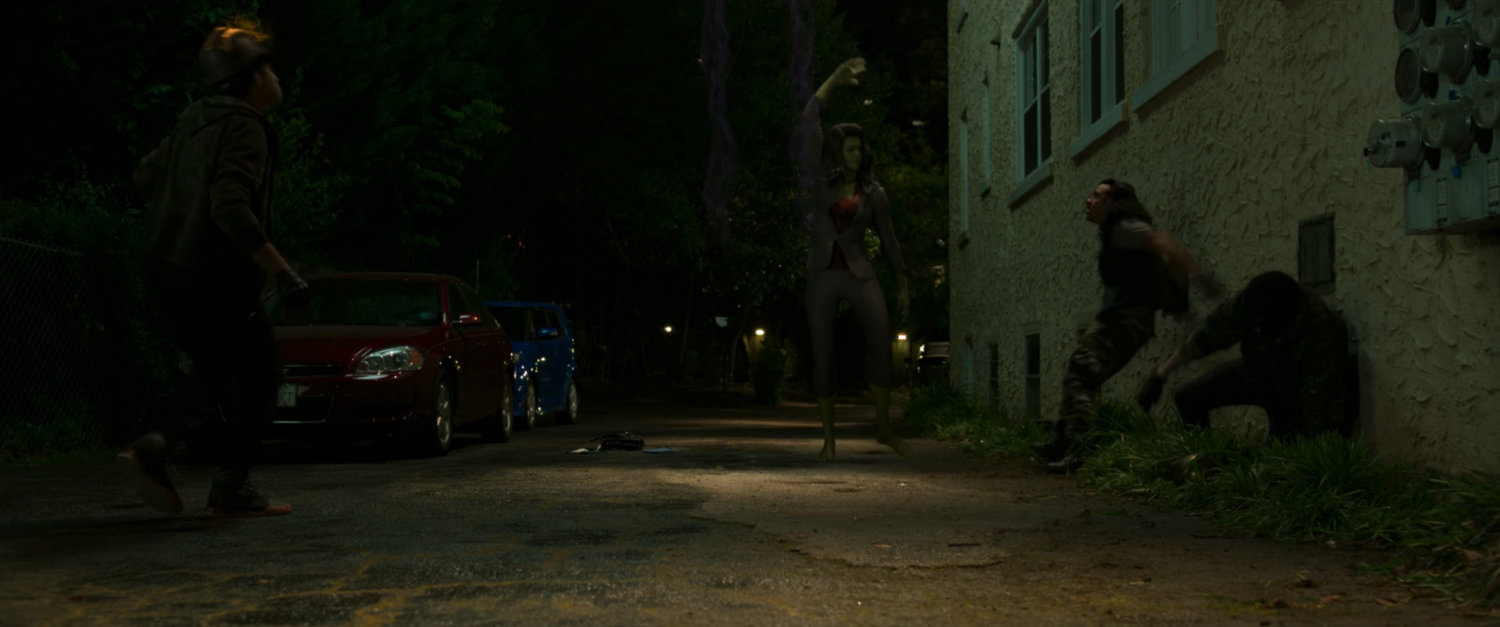 She-Hulk punches members of the Wrecking Crew on a side alley of her apartment building.