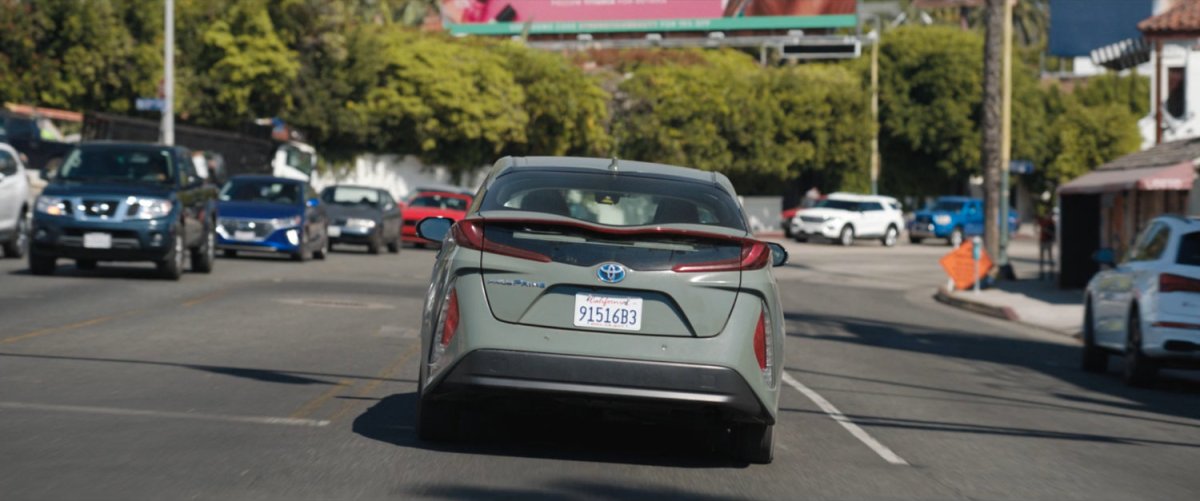 A green Prius drive east on Sunset Boulevard.