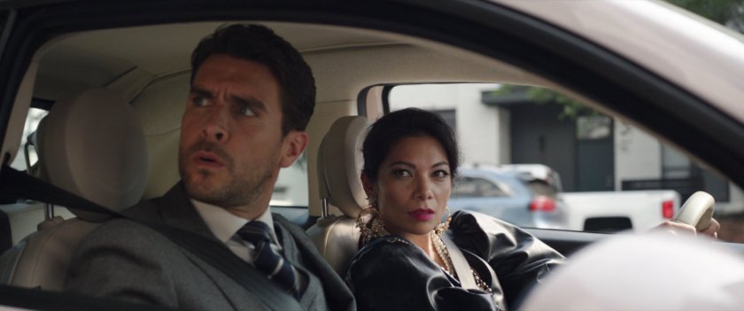 Pug and Nikki sitting in their car outside Café Beau-Ba.