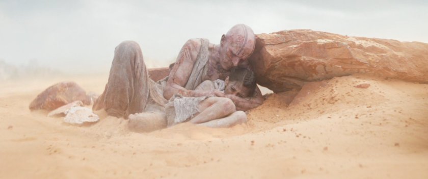 Gorr cradles his daughter in the desert.