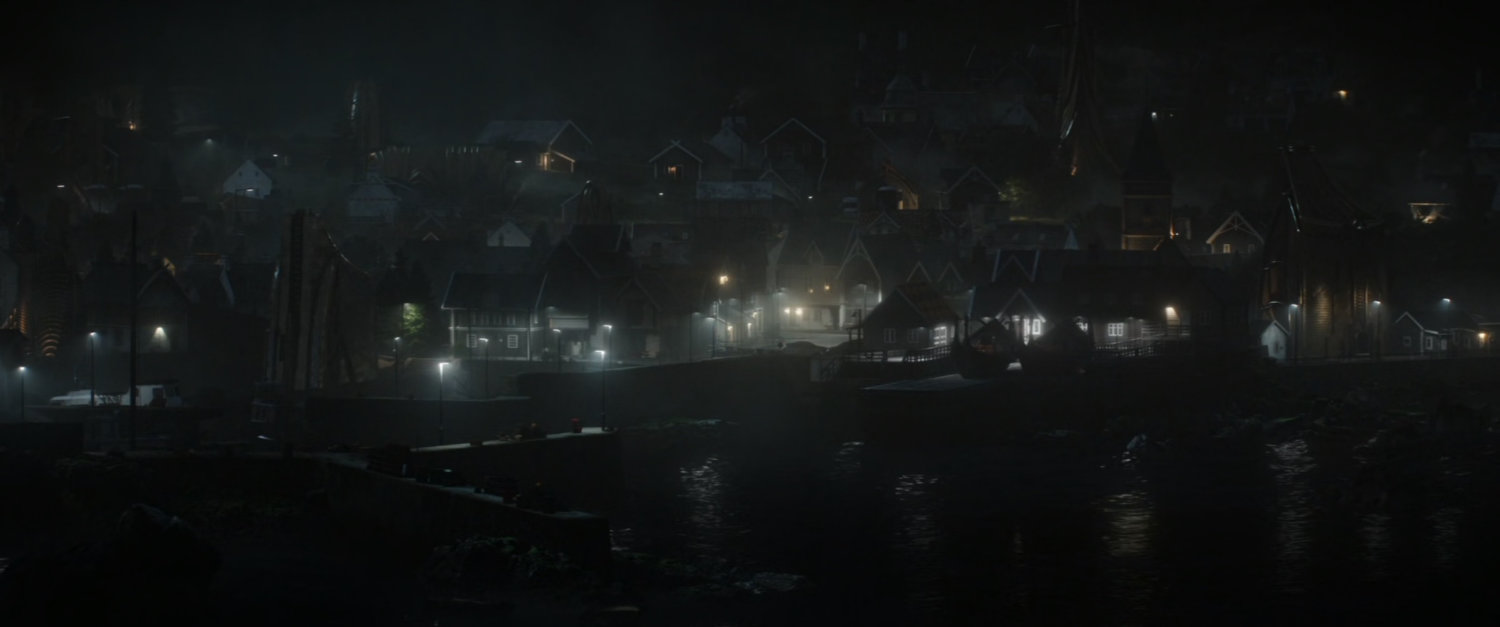 Foggy night time shot of the town of New Asgard.