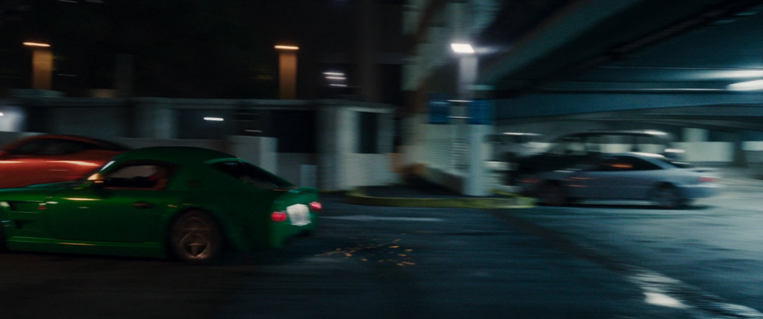 a car races out of a parking garage.