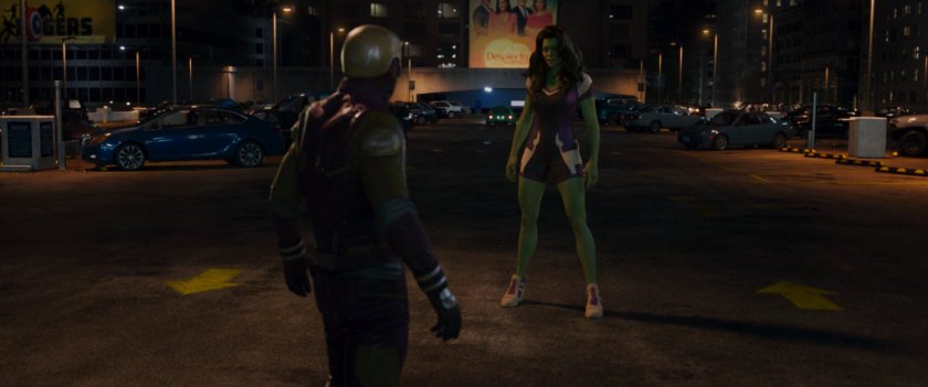 Daredevil and She-Hulk stand in a parking lot.