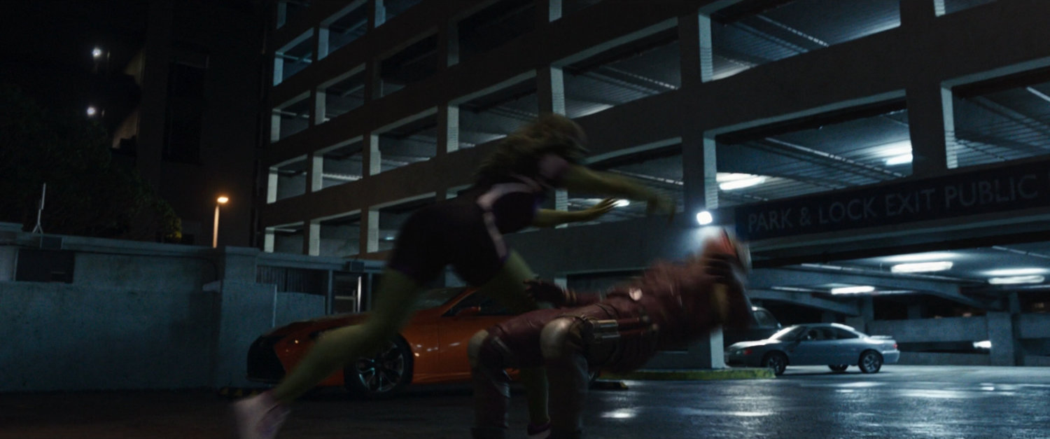 She-Hulk attacks Daredevil in a parking lot.