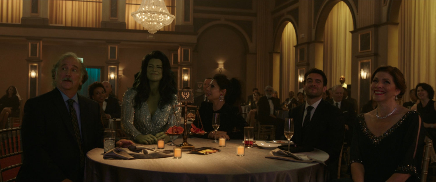 She-Hulk, her parents and Nikki and Pug sitting at a table in the Southern California Law Awards Gala.