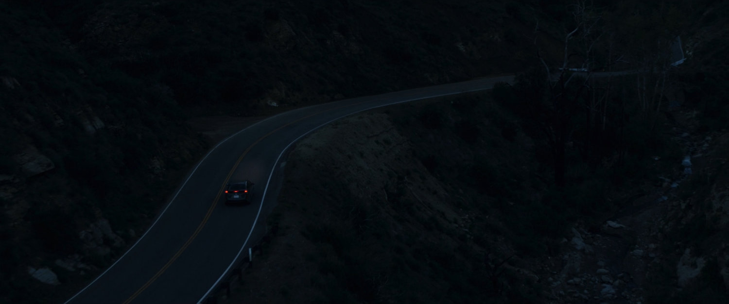 Aerial view of mountain road at night.