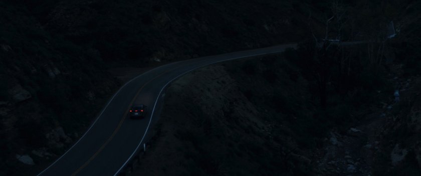 Aerial view of mountain road at night.