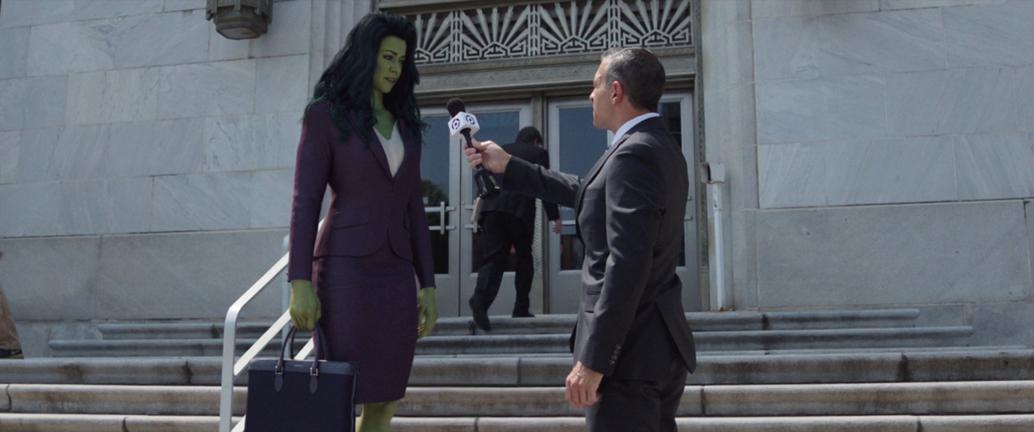 She-Hulk interviewed by a reporter on the courthouse steps.